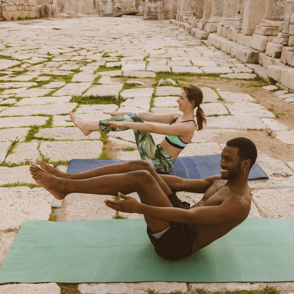 A diverse group of people smiling during a calm yoga session.